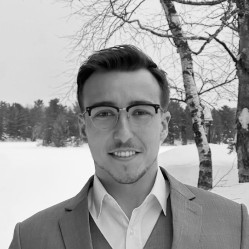 Charles Grin in a suit outdoors in winter