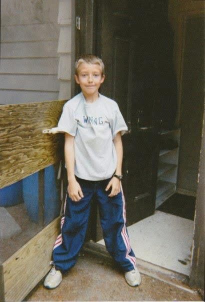 Childhood photograph of Charles outside a local building