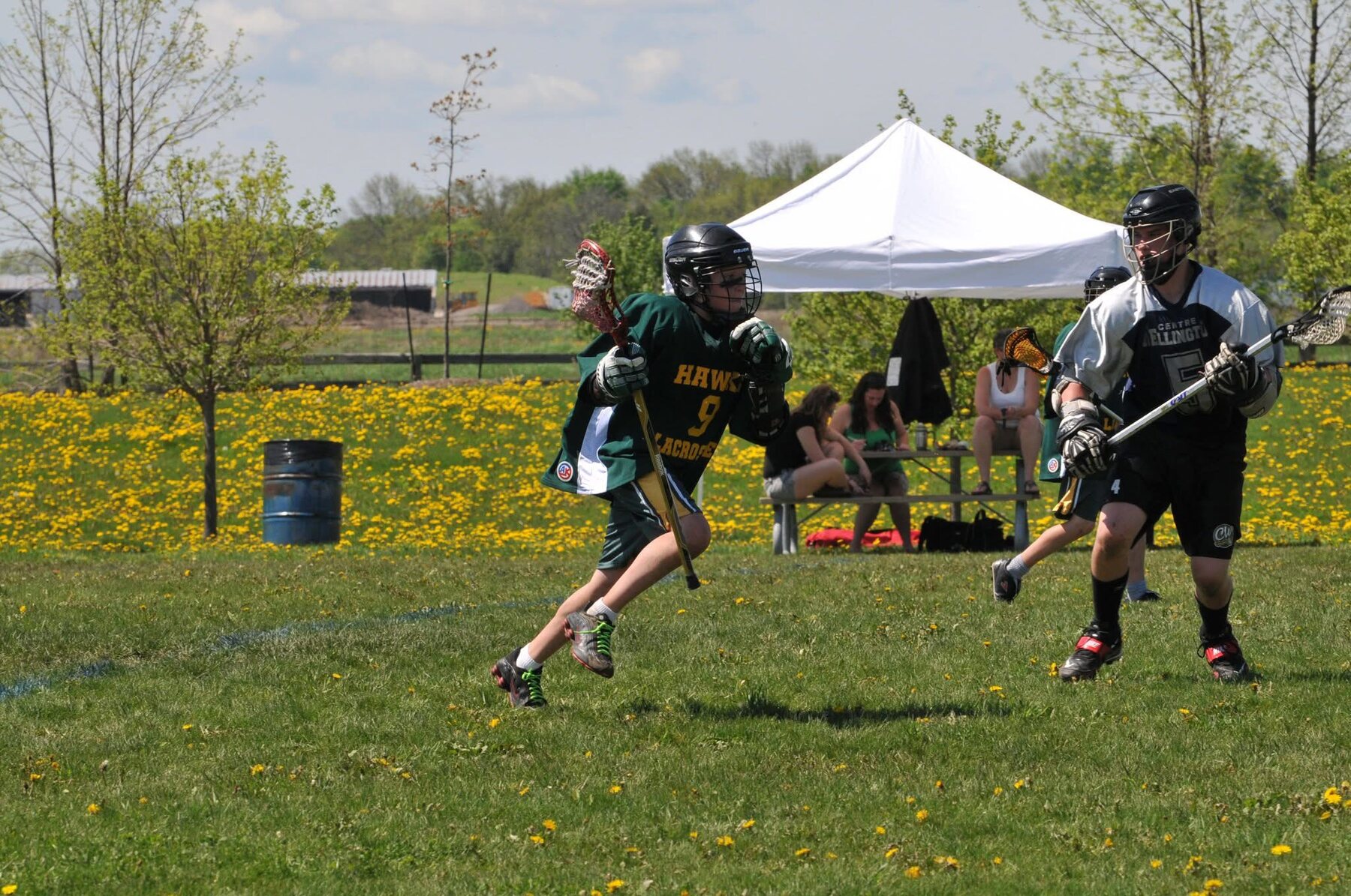 Charles playing lacrosse outdoors